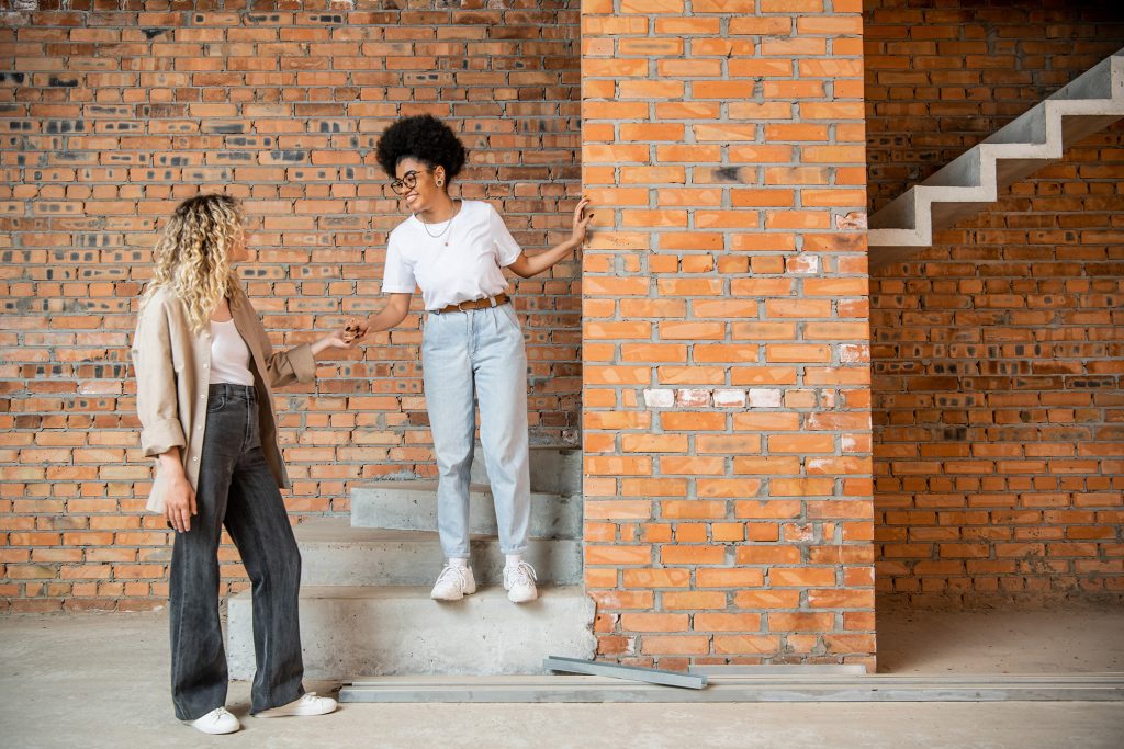 happy multiethnic same sex couple holding hands