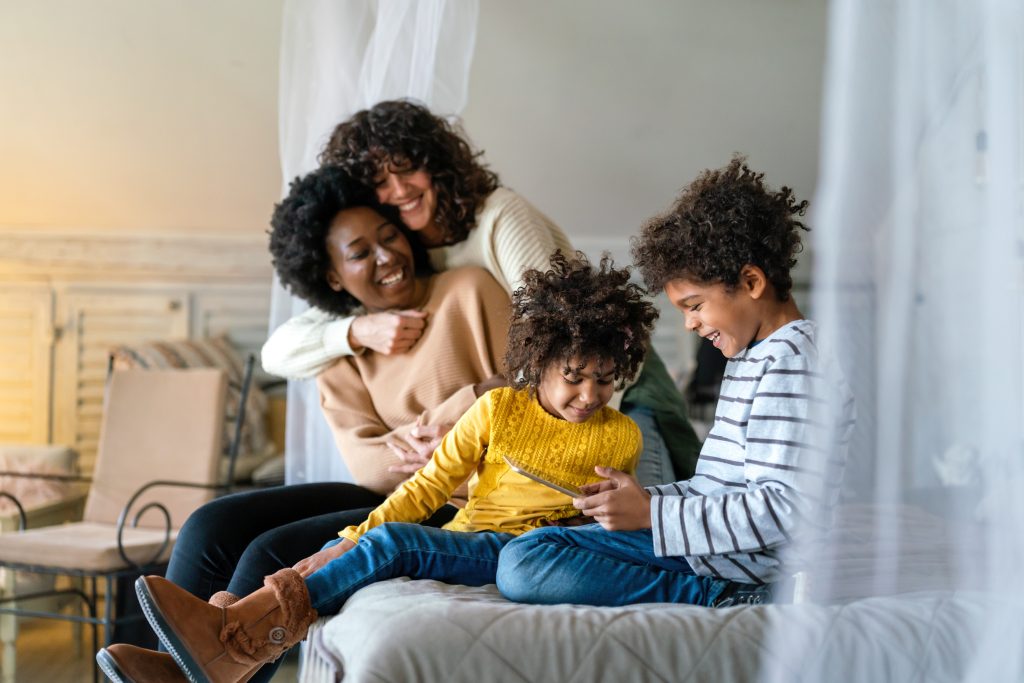 Happy couple in love with children at home. 