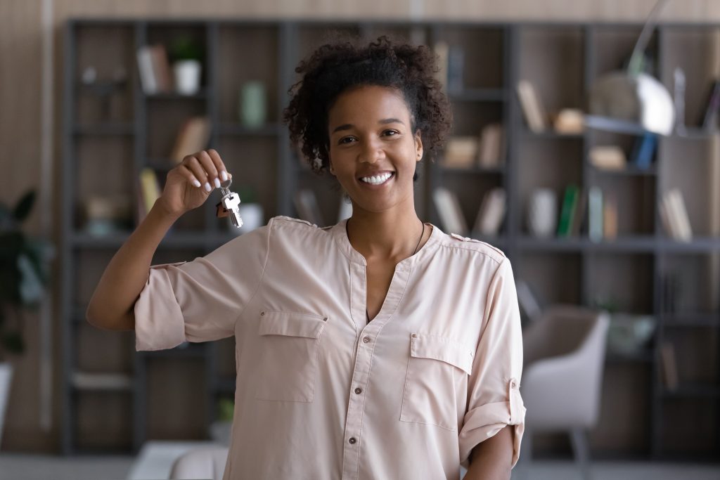 Portrait of smiling woman renter show house keys