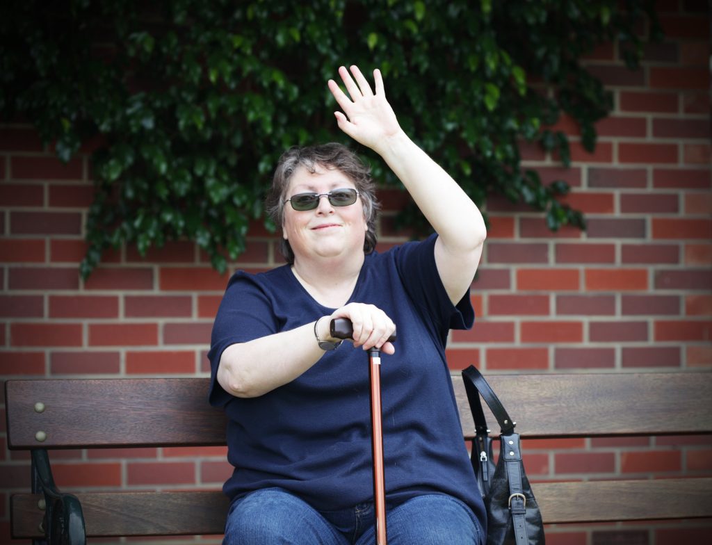 happy disabled woman saying hello